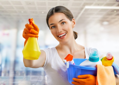 Carpet cleaning technician using safety procedures in a home