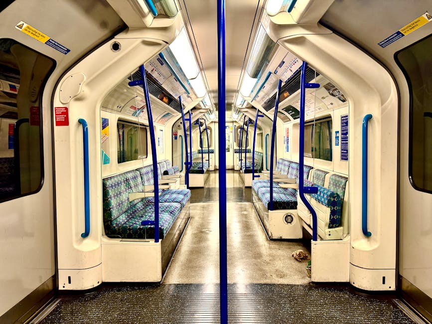 A pristine, white upholstered sofa with tufted backrest and rolled arms situated in a well-lit, elegant room with white paneled walls. The sofa rests on dark wooden legs, and the room features a polis